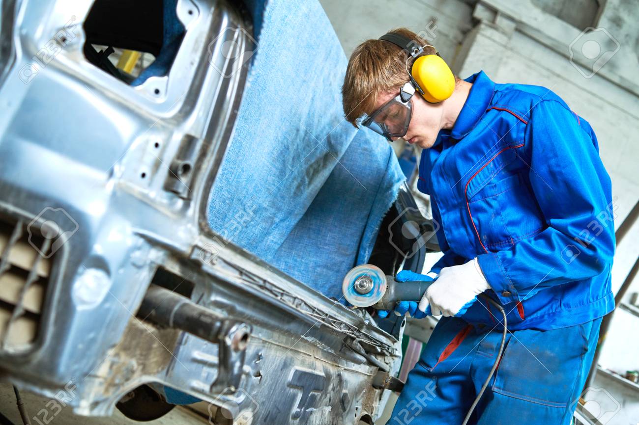 collision repairs service. mechanic grinding car body by grinder - 107412807 collision repairs service. mechanic grinding car body by grinder - 107412807