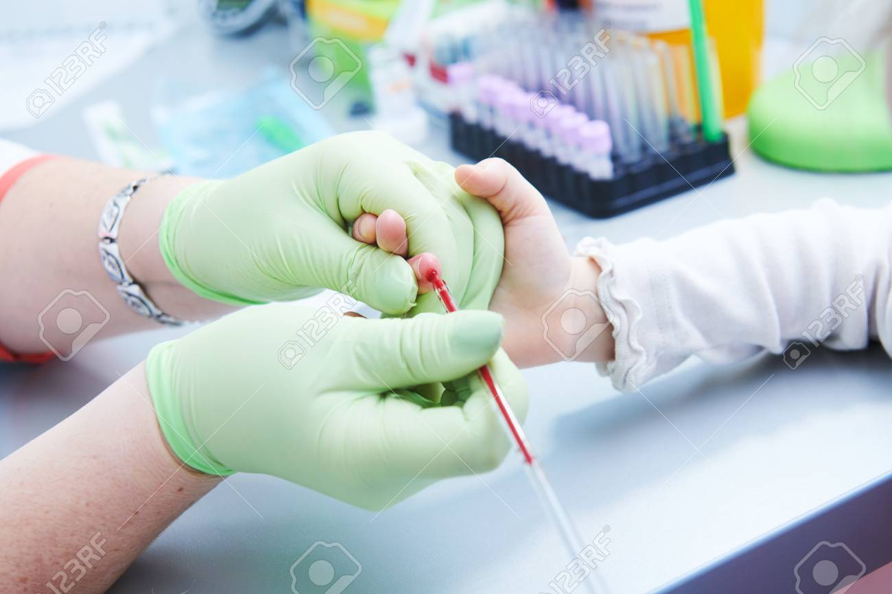 Blood medical test or research. Taking a blood sample from child finger in hospital - 115294306 Blood medical test or research. Taking a blood sample from child finger in hospital - 115294306