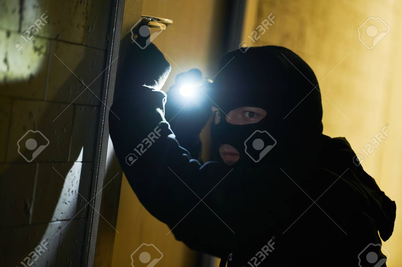 Burglar thief in mask. break-in of an apartment. - 118736084 Burglar thief in mask. break-in of an apartment. - 118736084
