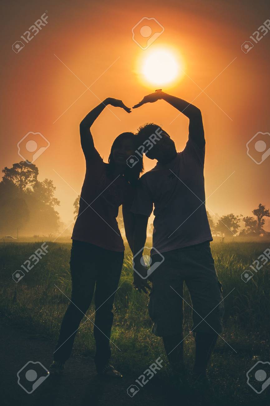 Silhouette Of Lovely Couple Against Sunset Blow Arm To Heart Stock Photo Picture And Royalty Free Image Image
