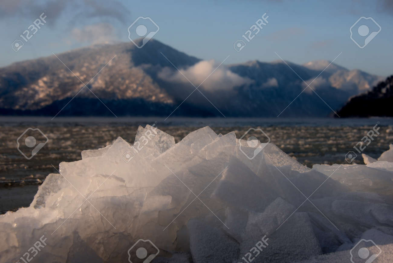 Russia. mountain Altai. Evening light in ice floods and icicles on the shore of lake Teletskoye. - 150397981 Russia. mountain Altai. Evening light in ice floods and icicles on the shore of lake Teletskoye. - 150397981