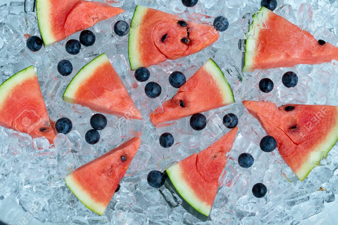 Stock Photo Watermelon Sliced And Blueberries On Ice Tube Background Stock Photo Watermelon Sliced And Blueberries On Ice Tube Background