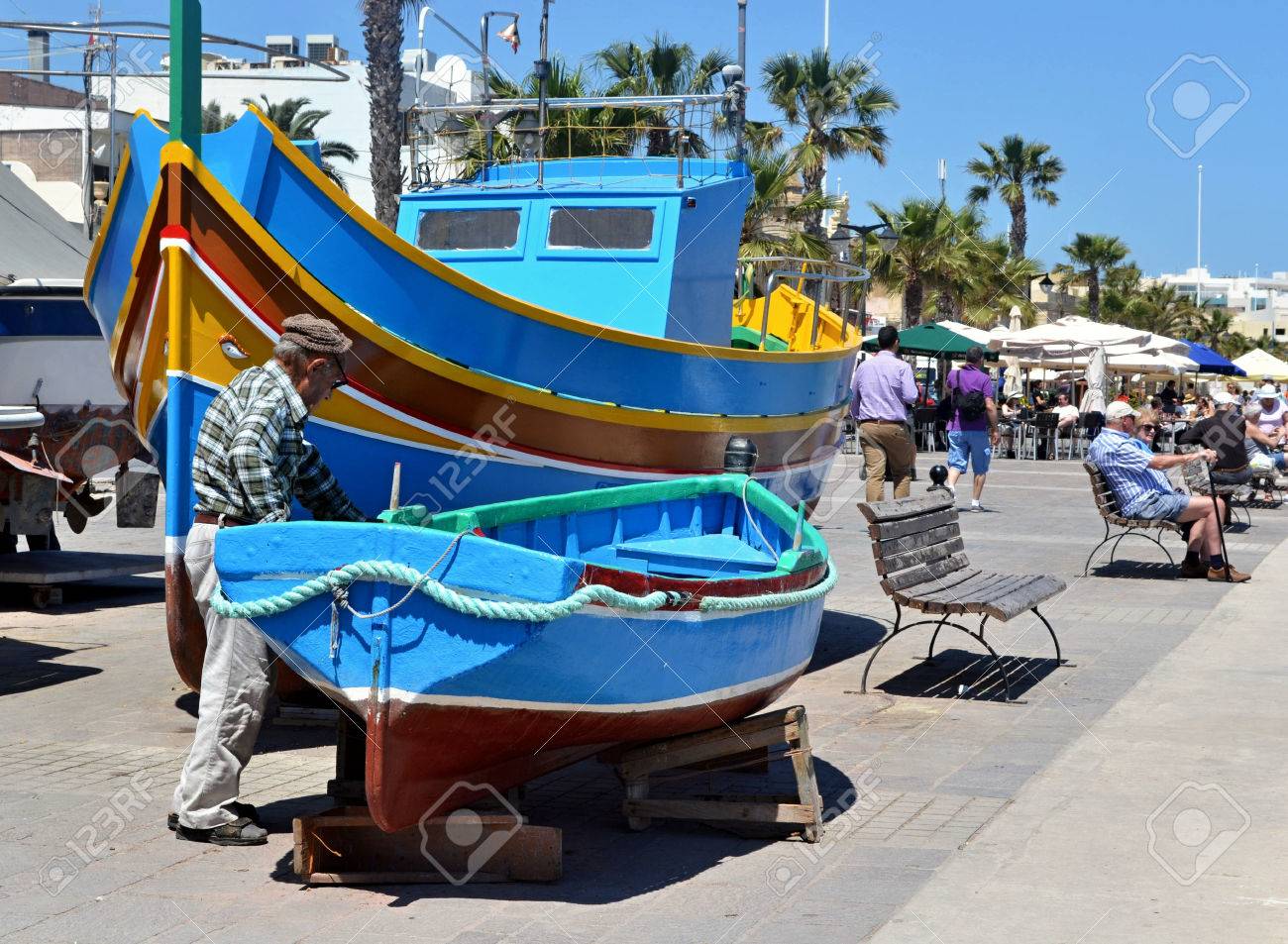 Fisherman Checking His Boat In Luzzu Port In Marsaxlokk Malta Stock Photo Picture And Royalty Free Image Image