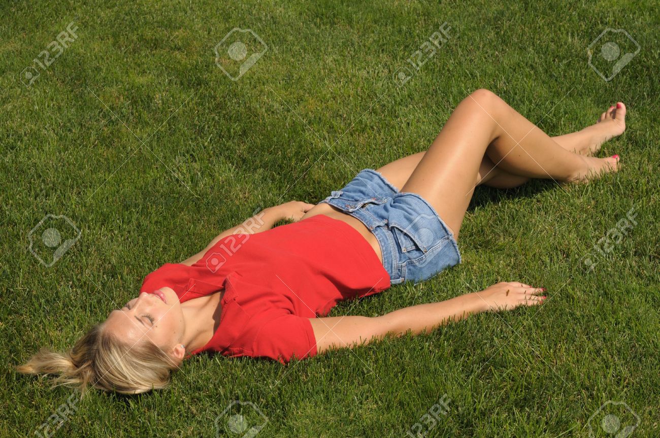 Beautiful Woman Is Lie Down On The Grass Stock Photo, Picture And ...