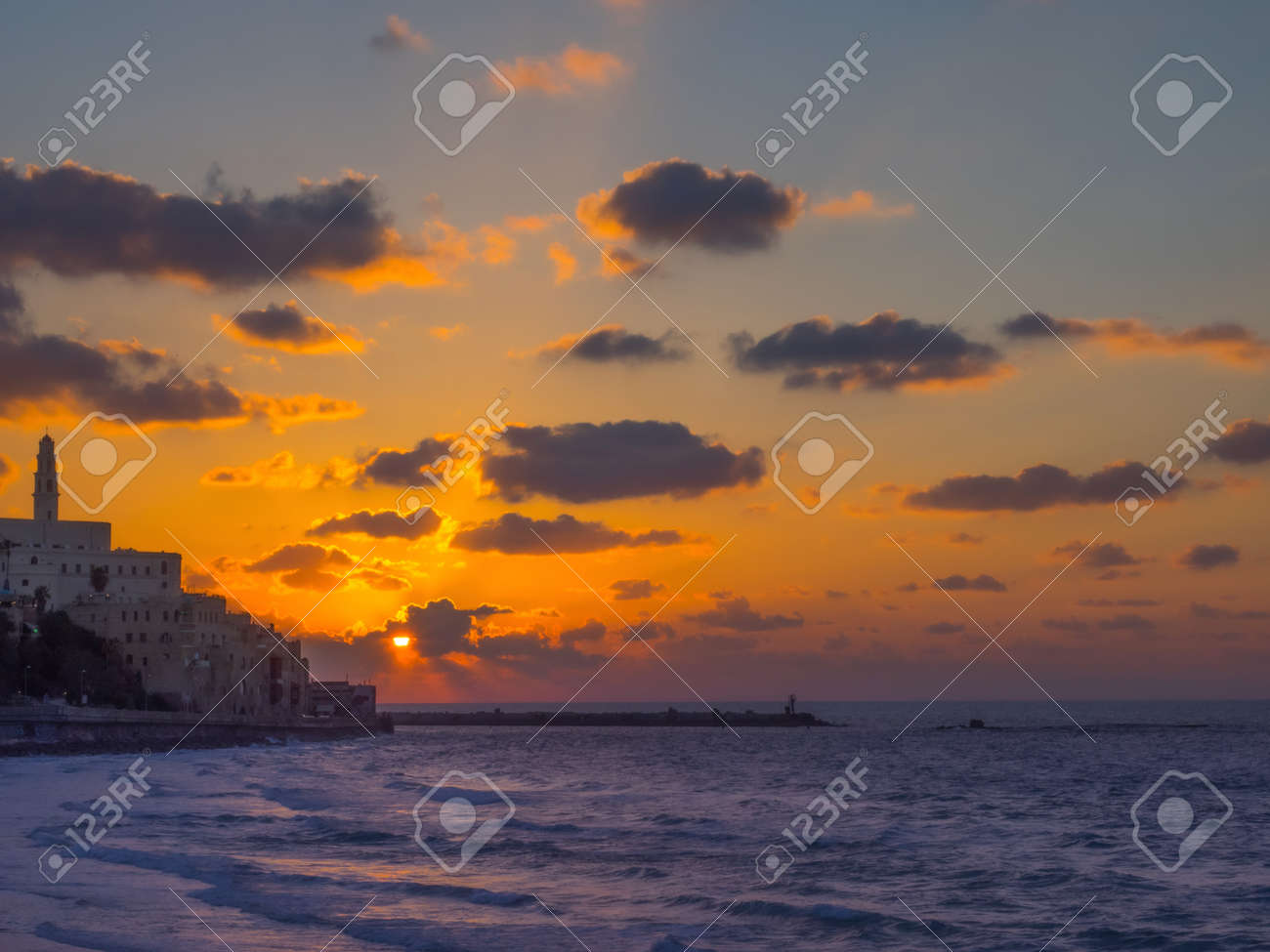 Coastal view of the ancient city of Yafo or Jaffanear Tel Aviv, Israel. Cityscape in sunset hour with clouds in the sky. - 170251309 Coastal view of the ancient city of Yafo or Jaffanear Tel Aviv, Israel. Cityscape in sunset hour with clouds in the sky. - 170251309