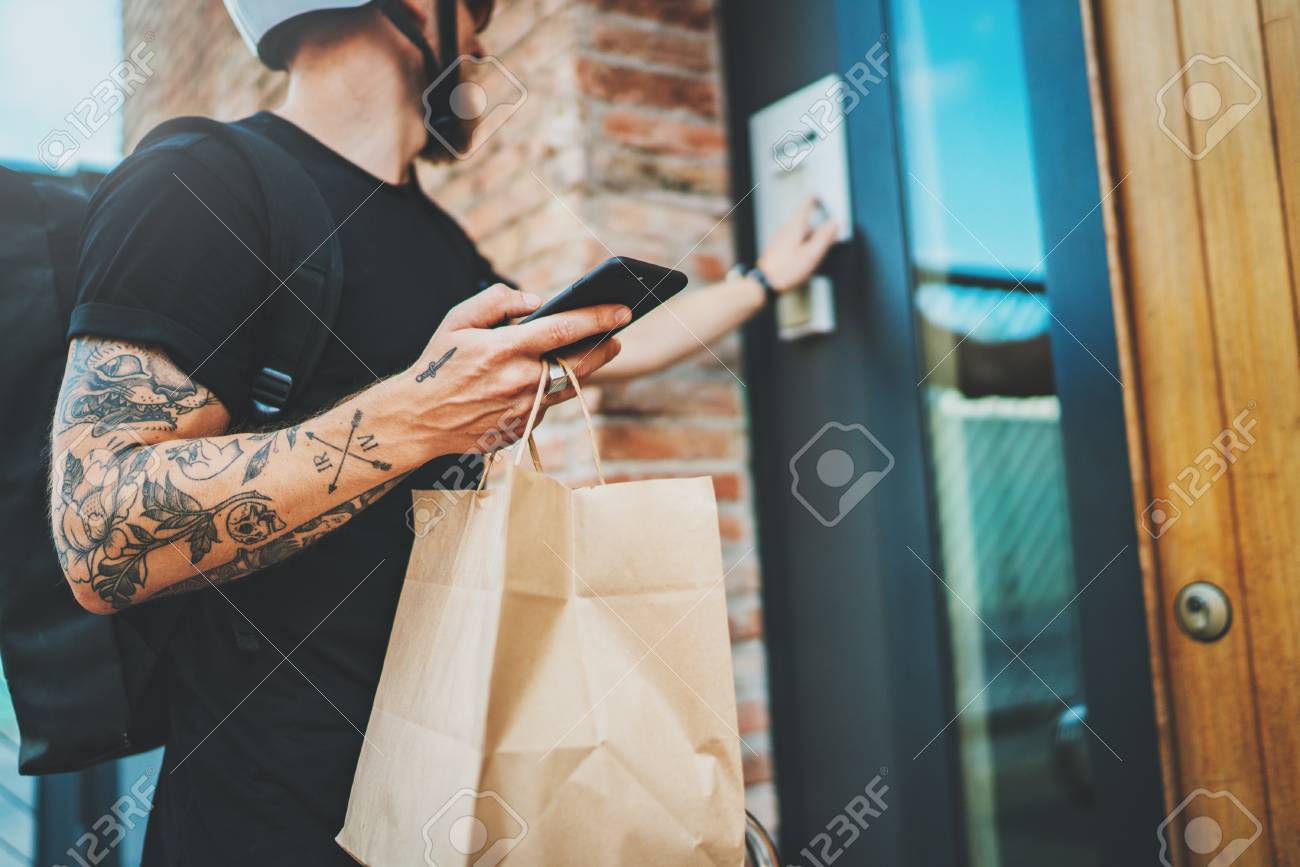 Courier delivery food service at home. Man courier delivered the order no name bag with food - 119477066 Courier delivery food service at home. Man courier delivered the order no name bag with food - 119477066