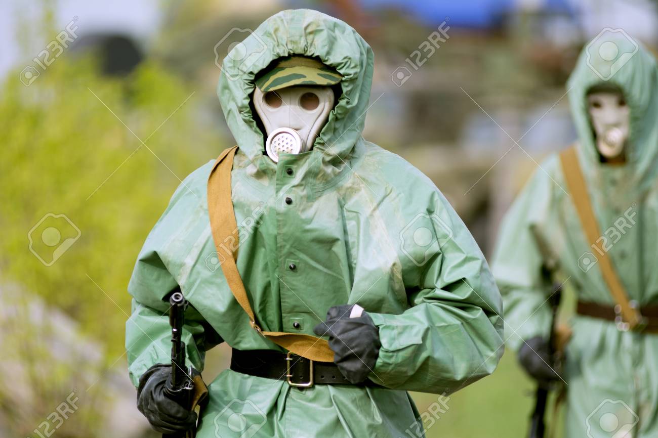 Military Man In Protective Suit And Gas Mask Outdoors. Are Holding An  Automatic Weapon Stock Photo, Picture and Royalty Free Image. Image  28350702., image size:1300x866