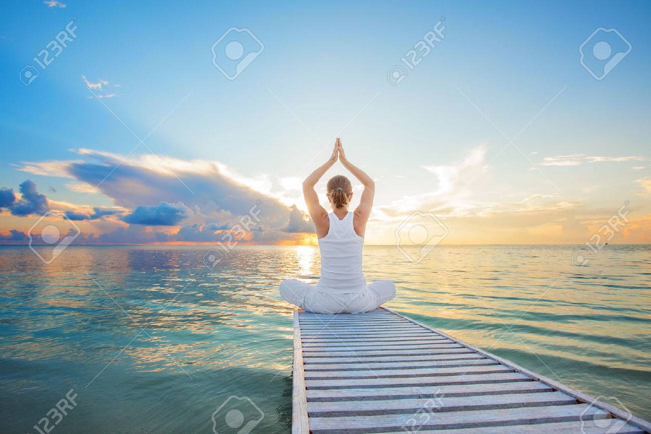 Caucasian woman practicing yoga at seashore - 22228289 Caucasian woman practicing yoga at seashore - 22228289