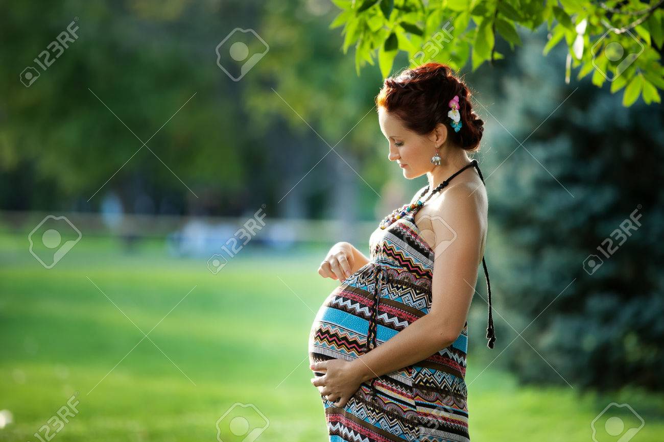 Pregnant caucasian woman takes rest outdoor - 22485326 Pregnant caucasian woman takes rest outdoor - 22485326