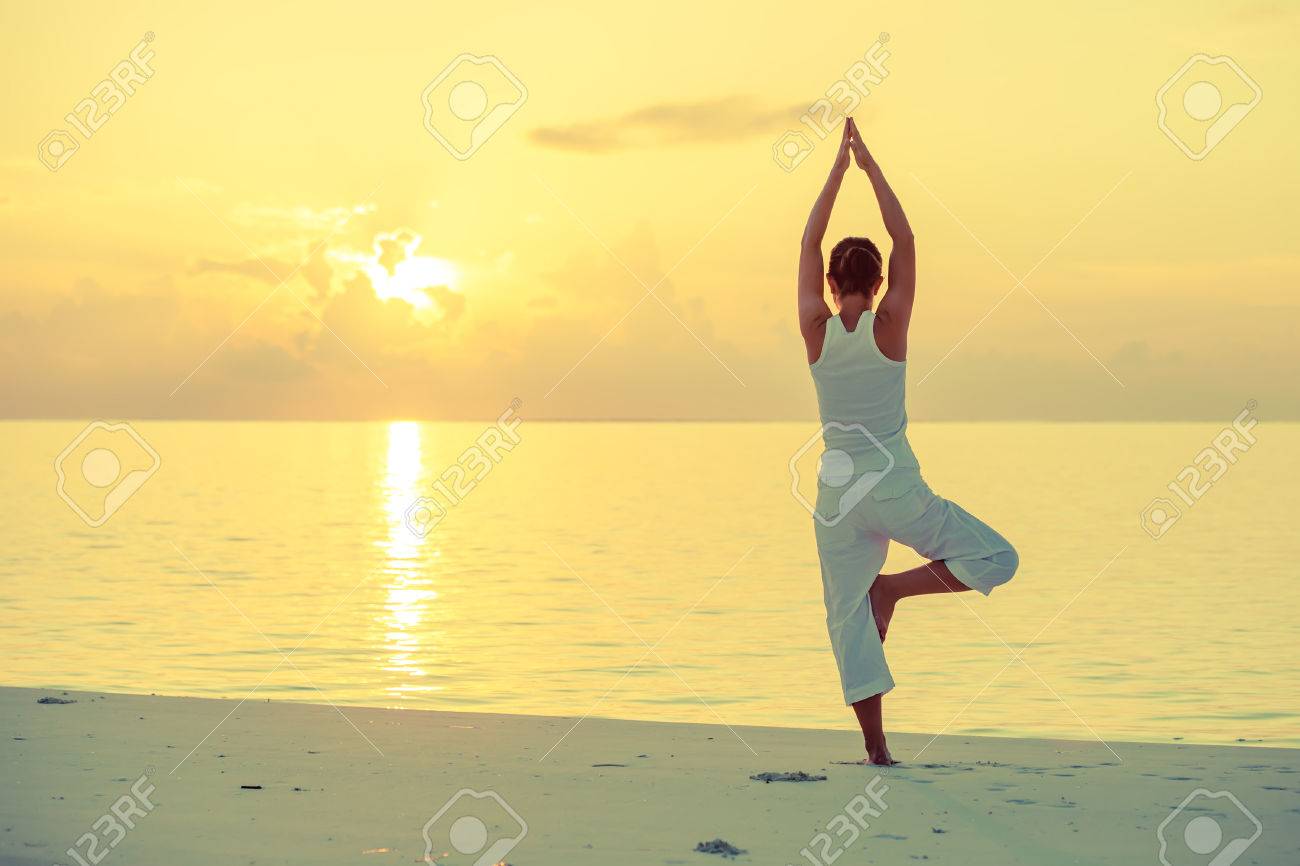 Caucasian woman practicing yoga at seashore - 22482402 Caucasian woman practicing yoga at seashore - 22482402