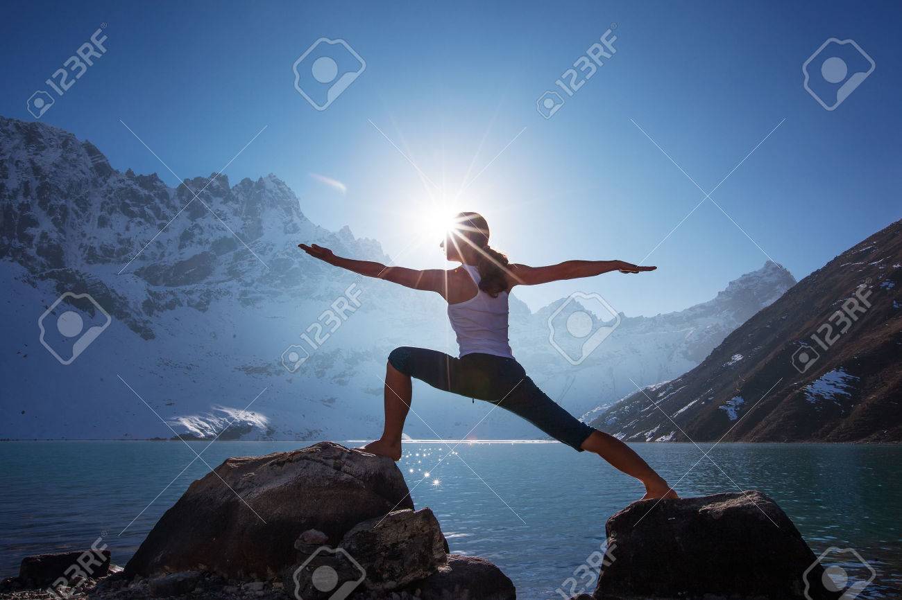 Young woman is practicing yoga at mountain lake - 35921631 Young woman is practicing yoga at mountain lake - 35921631
