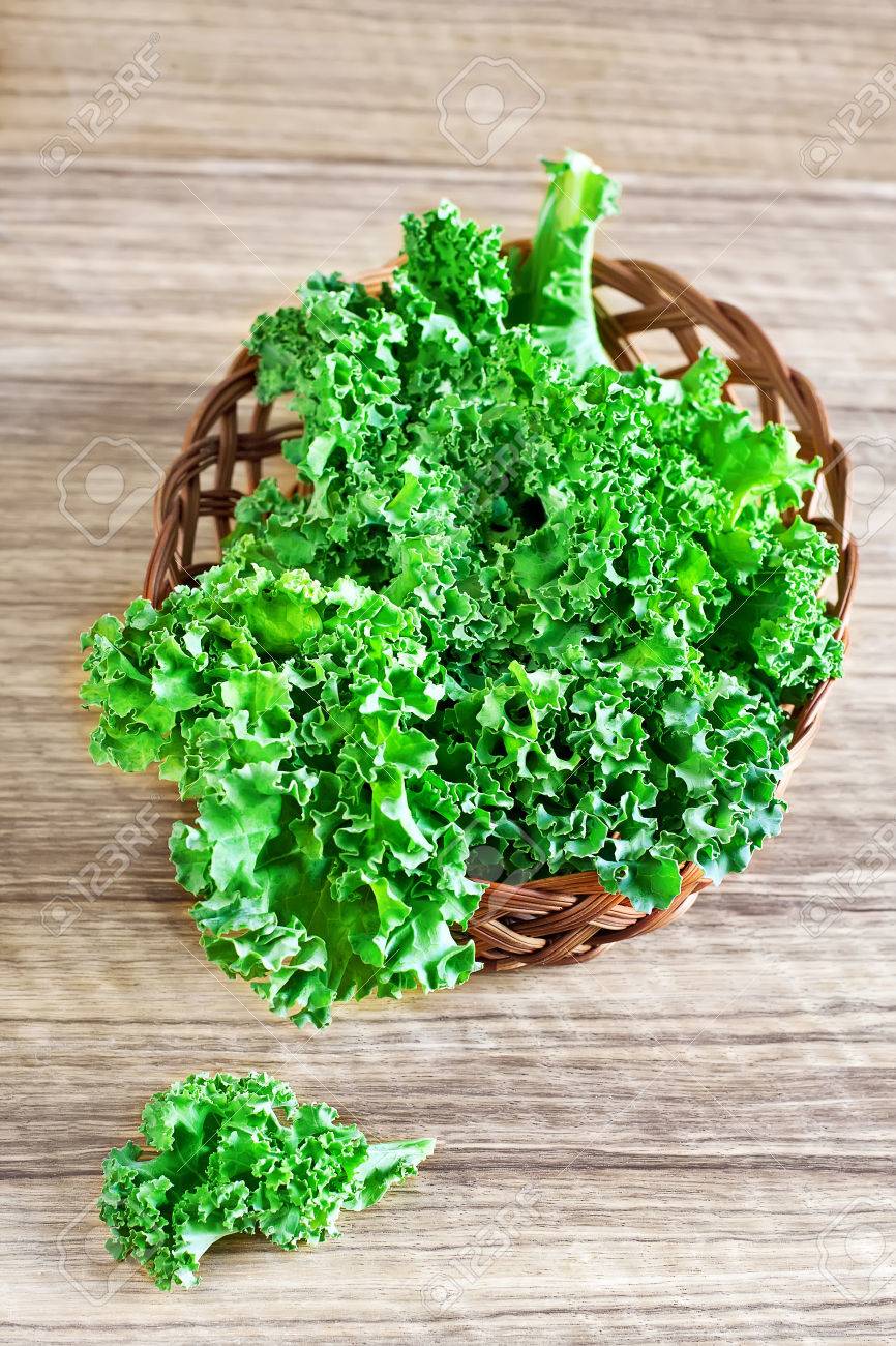Fresh green kale leaves in basket. Selective focus. - 27910802 Fresh green kale leaves in basket. Selective focus. - 27910802
