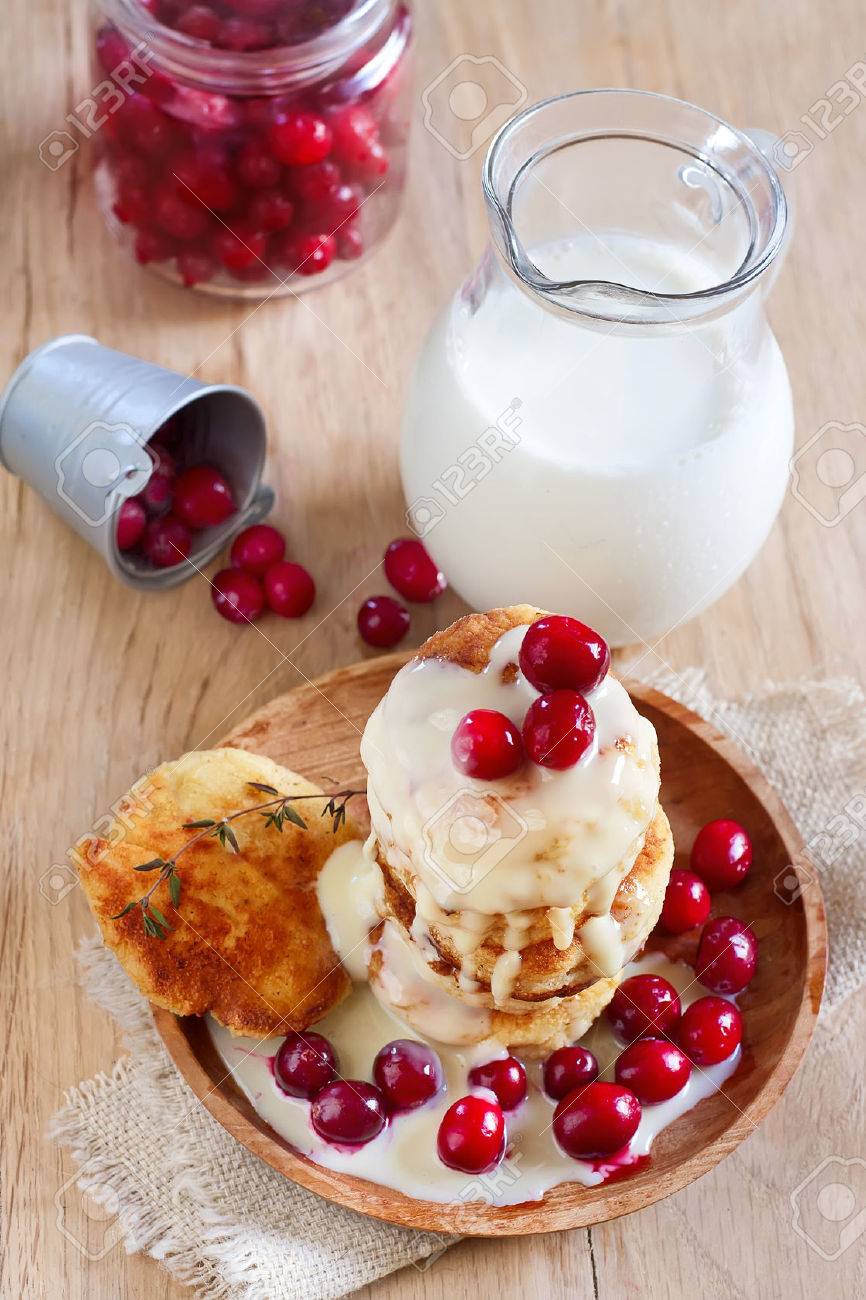 Russian quark pancakes with condensed milk and cranberry. Selective focus. - 28652668 Russian quark pancakes with condensed milk and cranberry. Selective focus. - 28652668