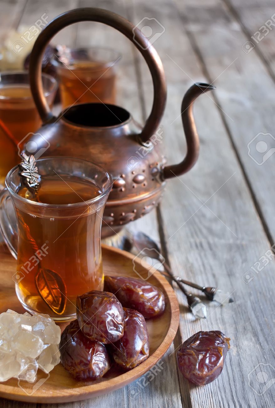 Traditional arabic tea with dry madjool dates and rock sugar nabot. Selective focus. Copy space background. - 29466744 Traditional arabic tea with dry madjool dates and rock sugar nabot. Selective focus. Copy space background. - 29466744