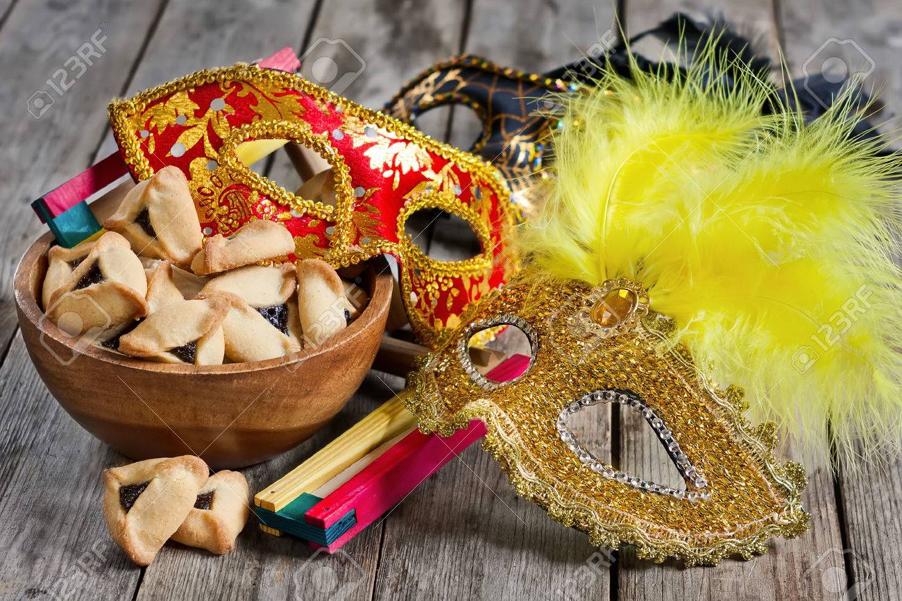 Hamantaschen cookies or Haman's ears, noisemaker and carnival masks for Purim celebration (jewish holiday). - 36978311 Hamantaschen cookies or Haman's ears, noisemaker and carnival masks for Purim celebration (jewish holiday). - 36978311