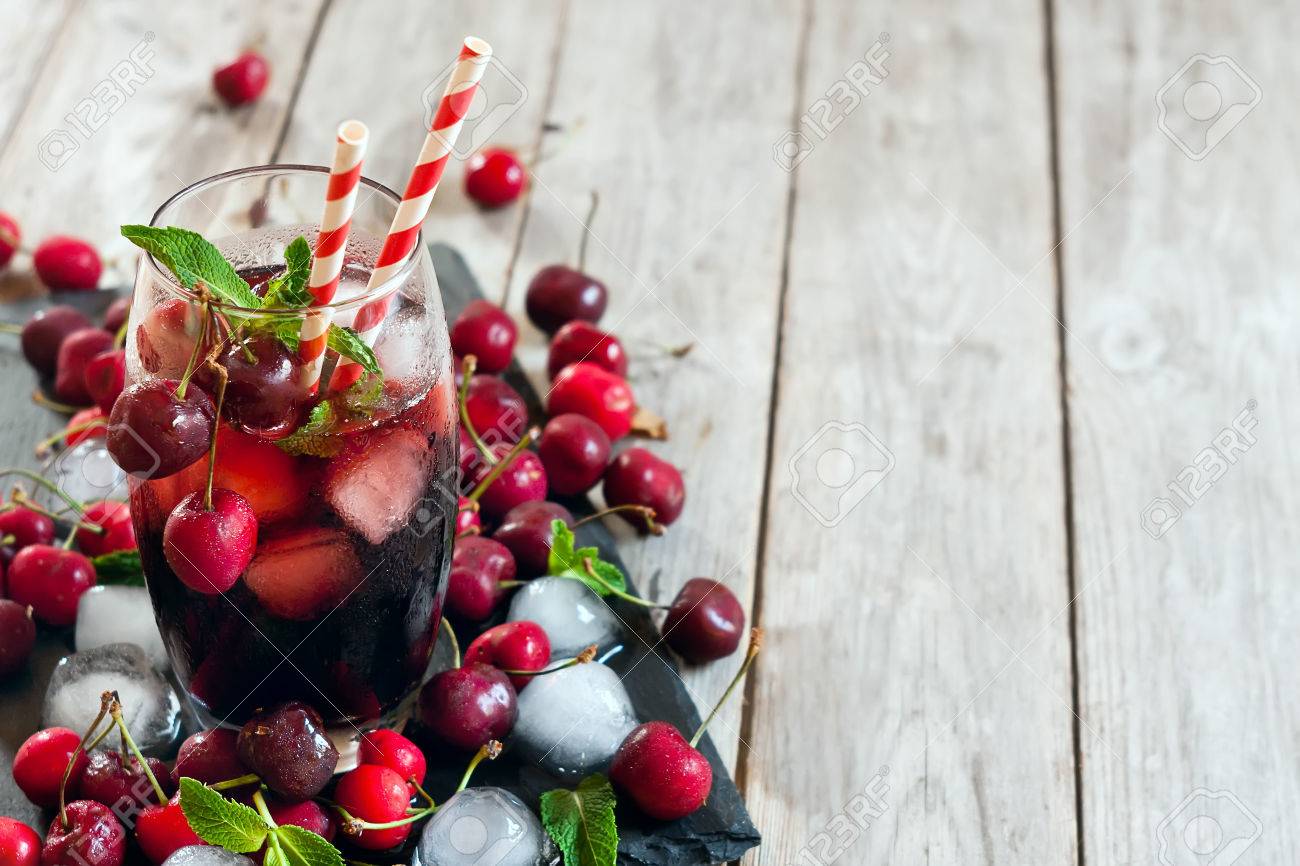 Cherry juice with ice cubes, mint leaves and ripe sweet cherry. Copy space background. - 41255919 Cherry juice with ice cubes, mint leaves and ripe sweet cherry. Copy space background. - 41255919