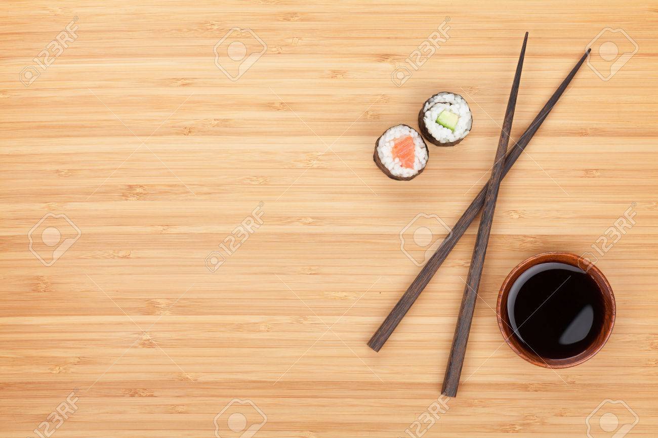 Maki Sushi, Chopsticks And Soy Sauce On Bamboo Wooden Table Maki Sushi, Chopsticks And Soy Sauce On Bamboo Wooden Table
