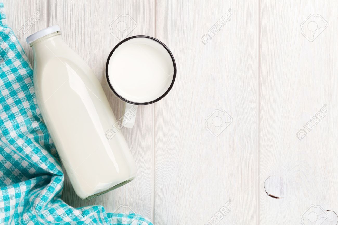 Table Top View milk cup and bottle on wooden table. top view with copy space Table Top View milk cup and bottle on wooden table. top view with copy space