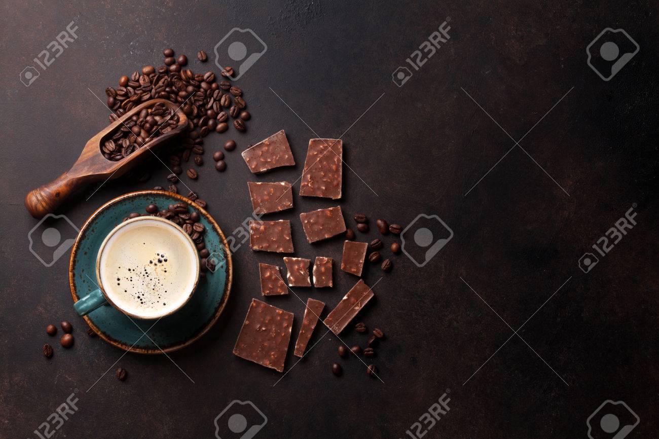 Coffee cup, beans and chocolate on old kitchen table. Top view with copyspace for your text - 75270851 Coffee cup, beans and chocolate on old kitchen table. Top view with copyspace for your text - 75270851