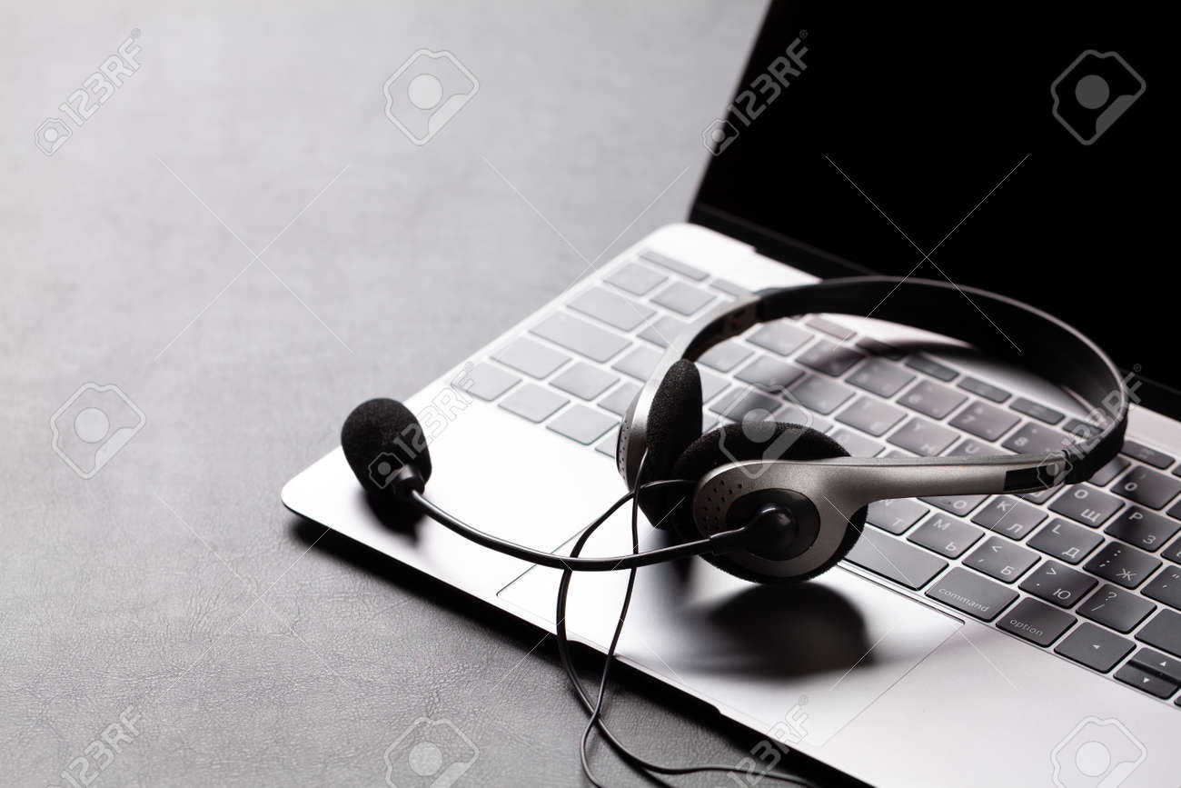 Office desk with headset and laptop. Remote office and work from home concept. With copy space - 158506997 Office desk with headset and laptop. Remote office and work from home concept. With copy space - 158506997