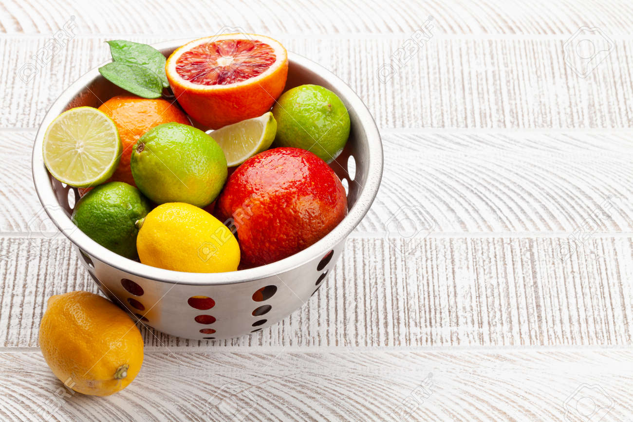 Various fresh citrus fruits in colander. Bood orange, lime, lemon. With copy space - 169549618 Various fresh citrus fruits in colander. Bood orange, lime, lemon. With copy space - 169549618