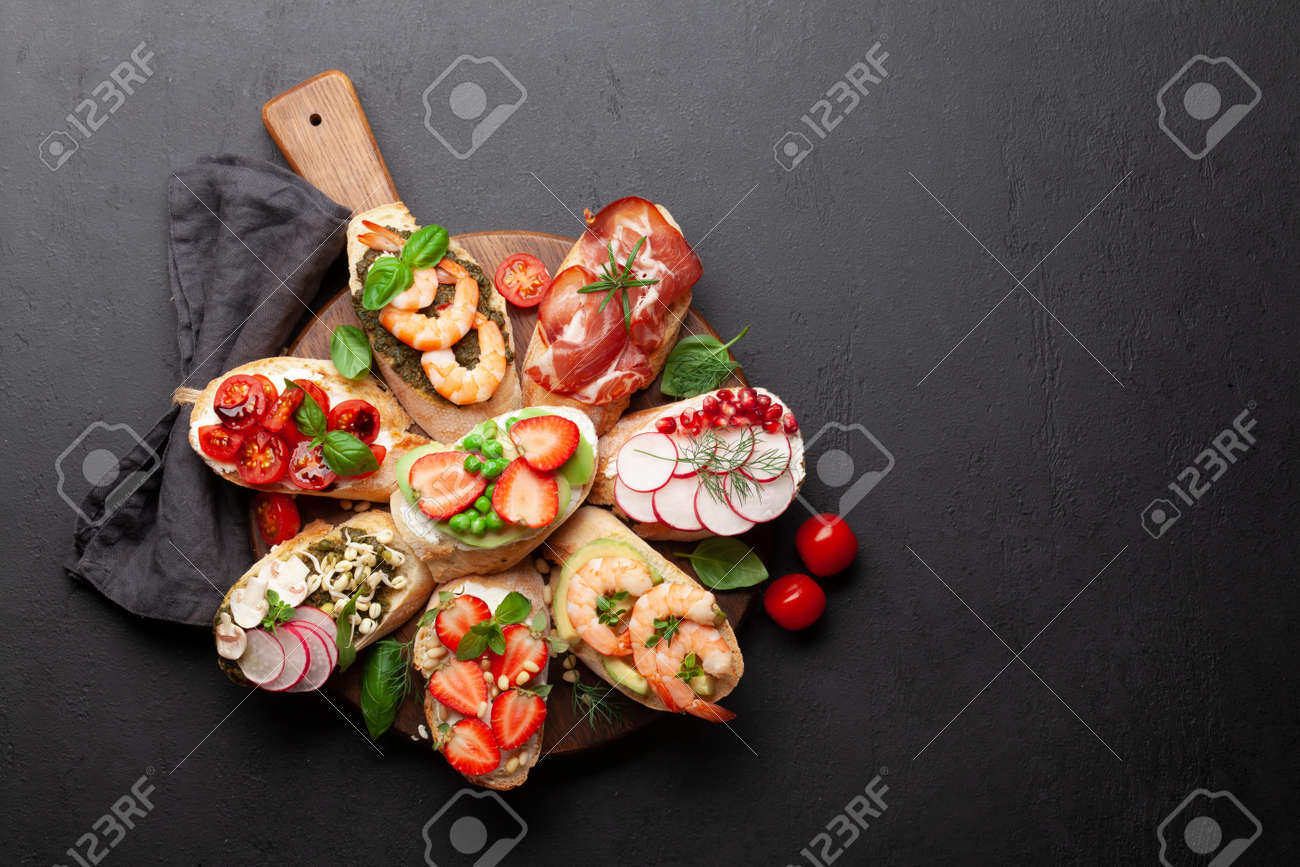 Appetizers plate with traditional spanish tapas set. Italian antipasti brushetta snacks. Top view flat lay with copy space - 169549718 Appetizers plate with traditional spanish tapas set. Italian antipasti brushetta snacks. Top view flat lay with copy space - 169549718