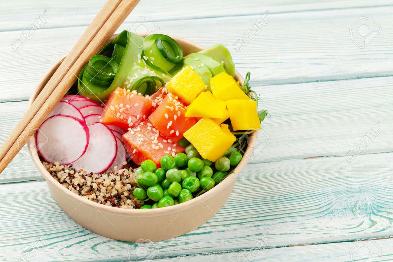 Poke bowl with salmon, cucumber and mango. Traditional hawaiian meal. With copy space - 169549810 Poke bowl with salmon, cucumber and mango. Traditional hawaiian meal. With copy space - 169549810