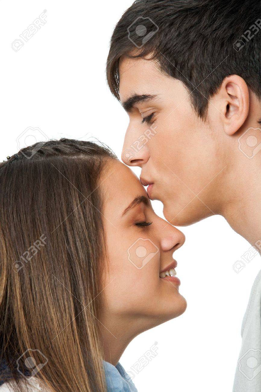 Close Up Of Boy Kissing Girlfriend On Forehead.Isolated On White. Stock  Photo, Picture And Royalty Free Image. Image 16659987.