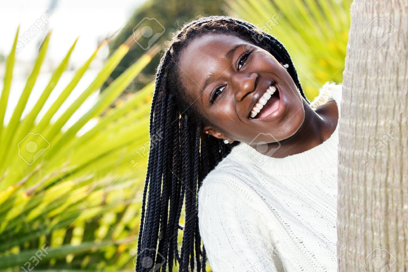 Close up fun portrait of happy african female teen with braided hairstyle outdoors. - 51235494 Close up fun portrait of happy african female teen with braided hairstyle outdoors. - 51235494