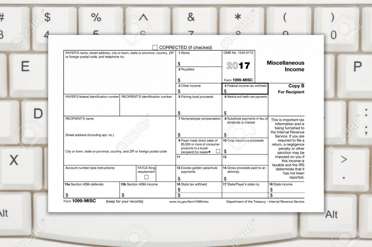A Us Federal Tax 1099 Income Tax Form On A Keyboard Stock Photo