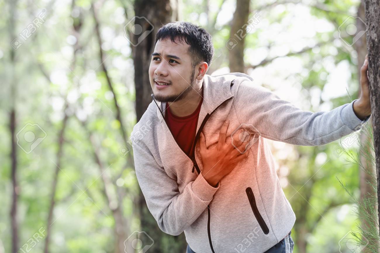 Asian cardiac arrest running young man heart attack in park.Severe heartache - 94145777 Asian cardiac arrest running young man heart attack in park.Severe heartache - 94145777