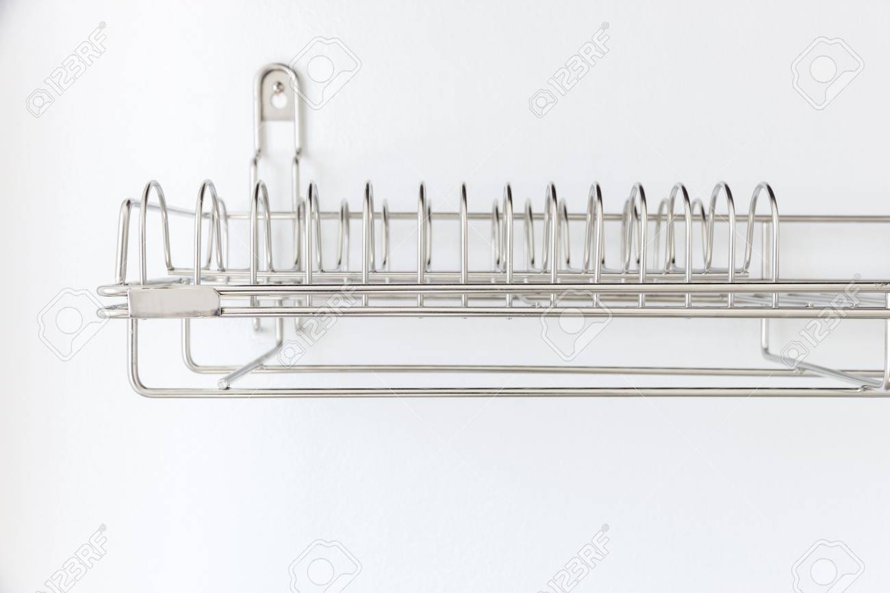 Stainless Steel Dish Rack On White Wall Inside Kitchen Cabinet