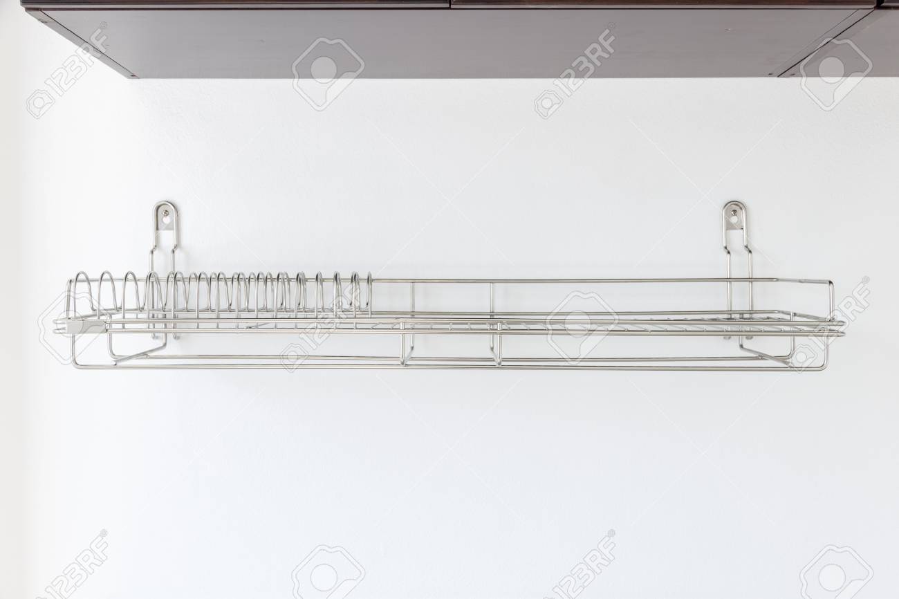 Stainless Steel Dish Rack On White Wall Inside Kitchen Cabinet