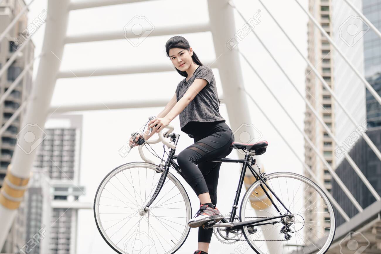 Lifestyle sport woman and health riding bike in city background - 122269772 Lifestyle sport woman and health riding bike in city background - 122269772