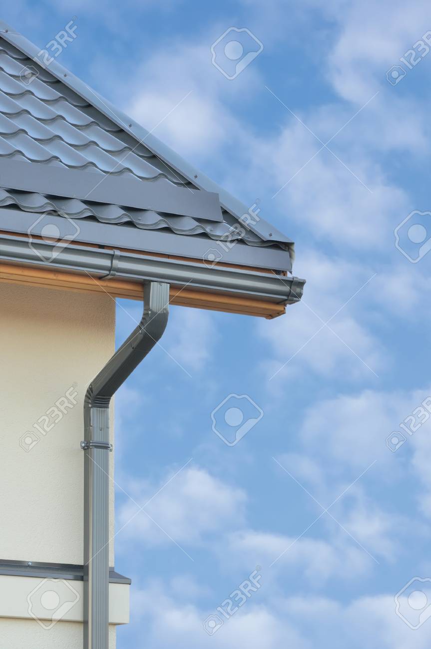 Grey steel tile roof texture background gray tiled roofing beige yellow plastered wall
