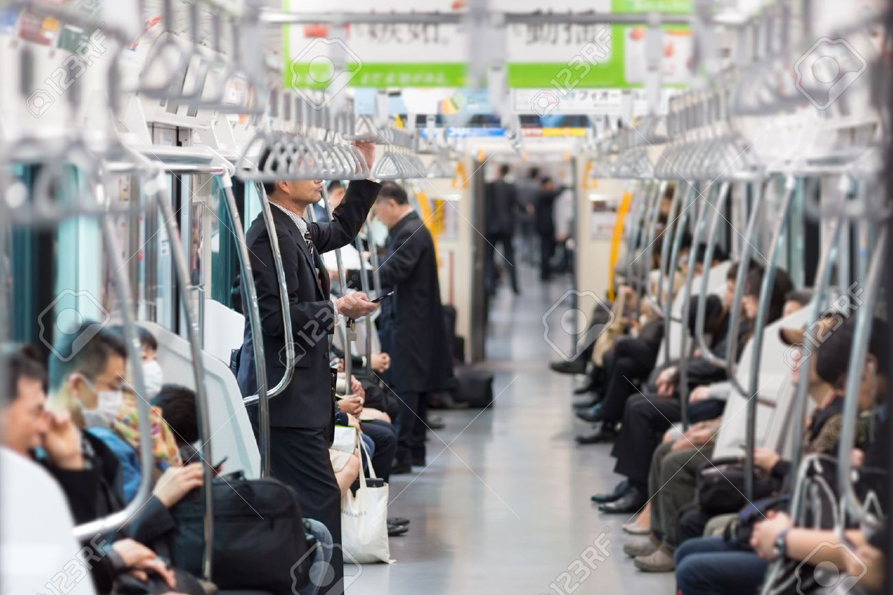 Passengers traveling by Tokyo metro. Business people commuting to work by public transport in rush hour. Shallow depth of field photo. - 53609257 Passengers traveling by Tokyo metro. Business people commuting to work by public transport in rush hour. Shallow depth of field photo. - 53609257