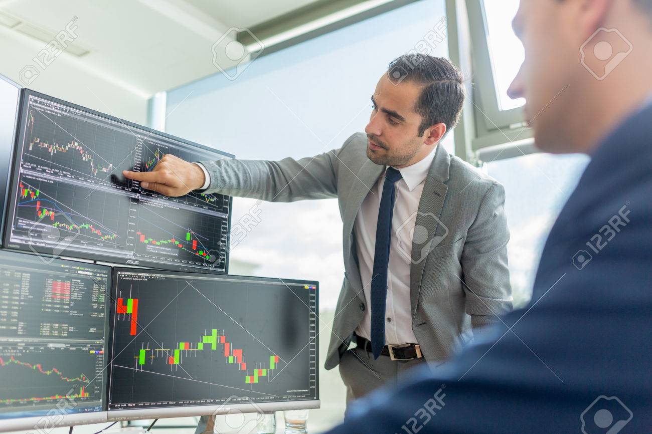 businessmen trading stocks online stock brokers looking at graphs stock brokers