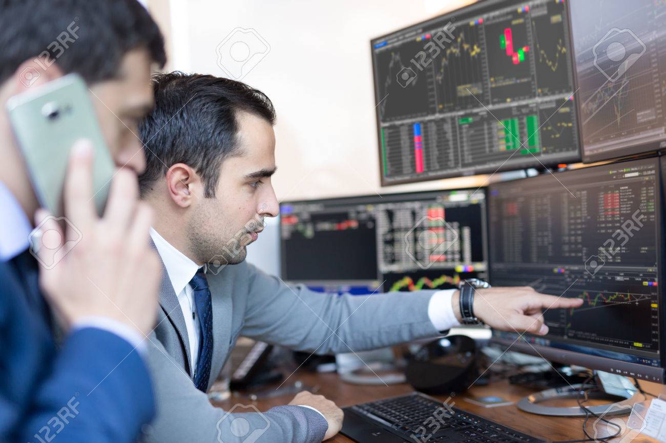businessmen trading stocks online stock brokers looking at graphs stock brokers