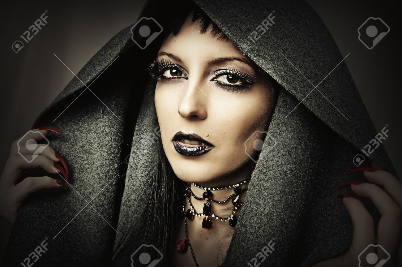 Young beautiful brunette woman in gray hood with fashion gothic make up and ancient necklace - 15127266 Young beautiful brunette woman in gray hood with fashion gothic make up and ancient necklace - 15127266