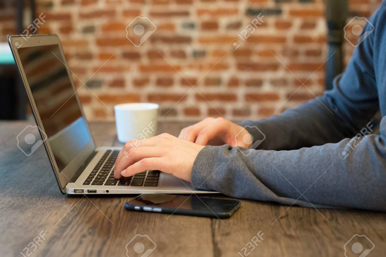 young man with his laptop in the room man searching the web searching the web