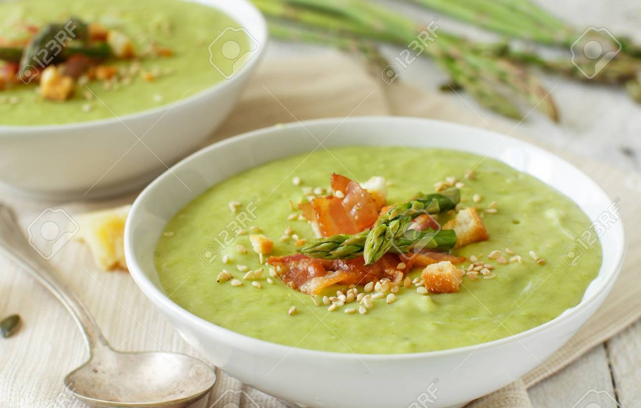 Creamy asparagus and potatoes soup puree on a wooden table - 111218694 Creamy asparagus and potatoes soup puree on a wooden table - 111218694