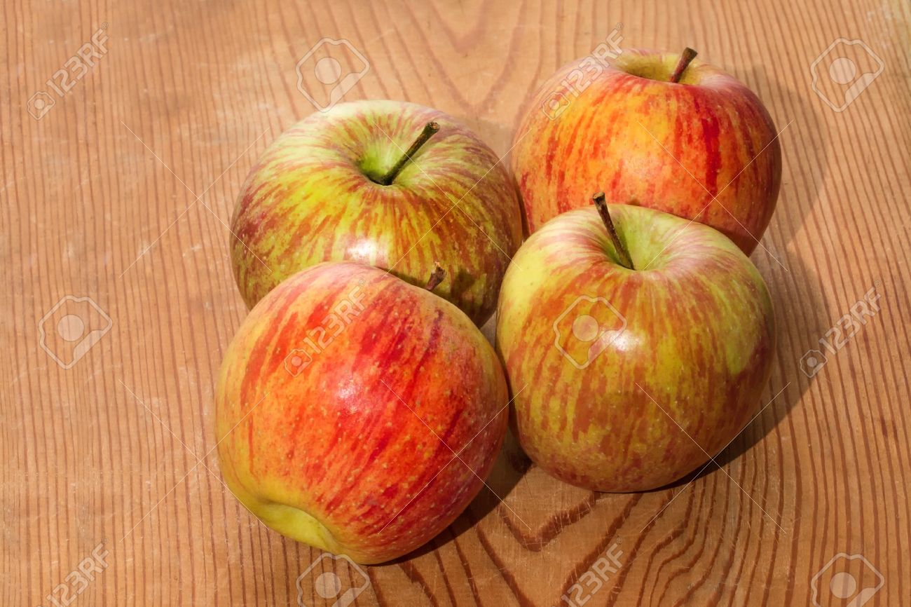 four apples on wooden table stock photo picture and royalty free