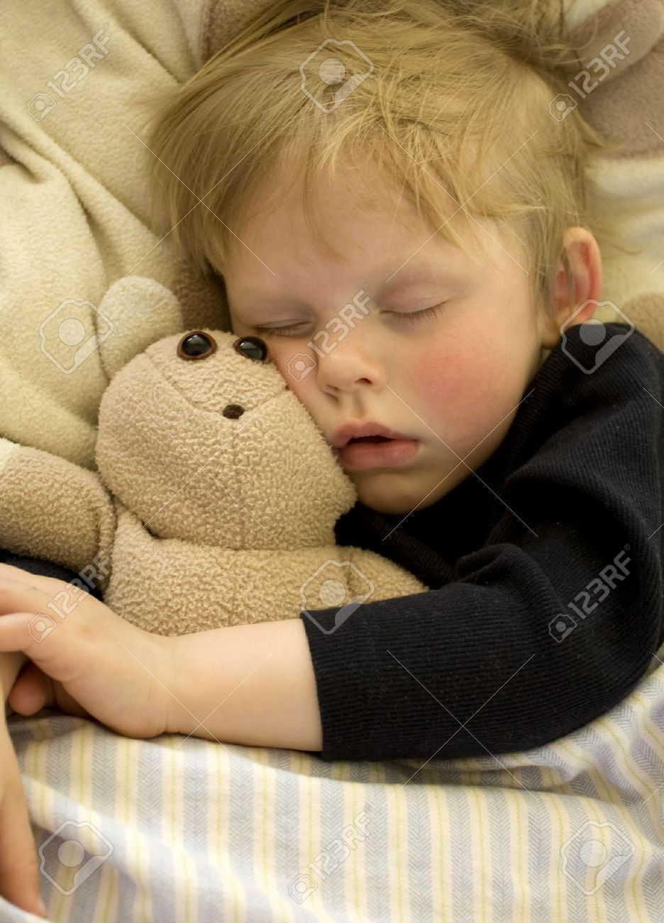 Cute sleeping child cuddling his teddy bear - 6965389 Cute sleeping child cuddling his teddy bear - 6965389