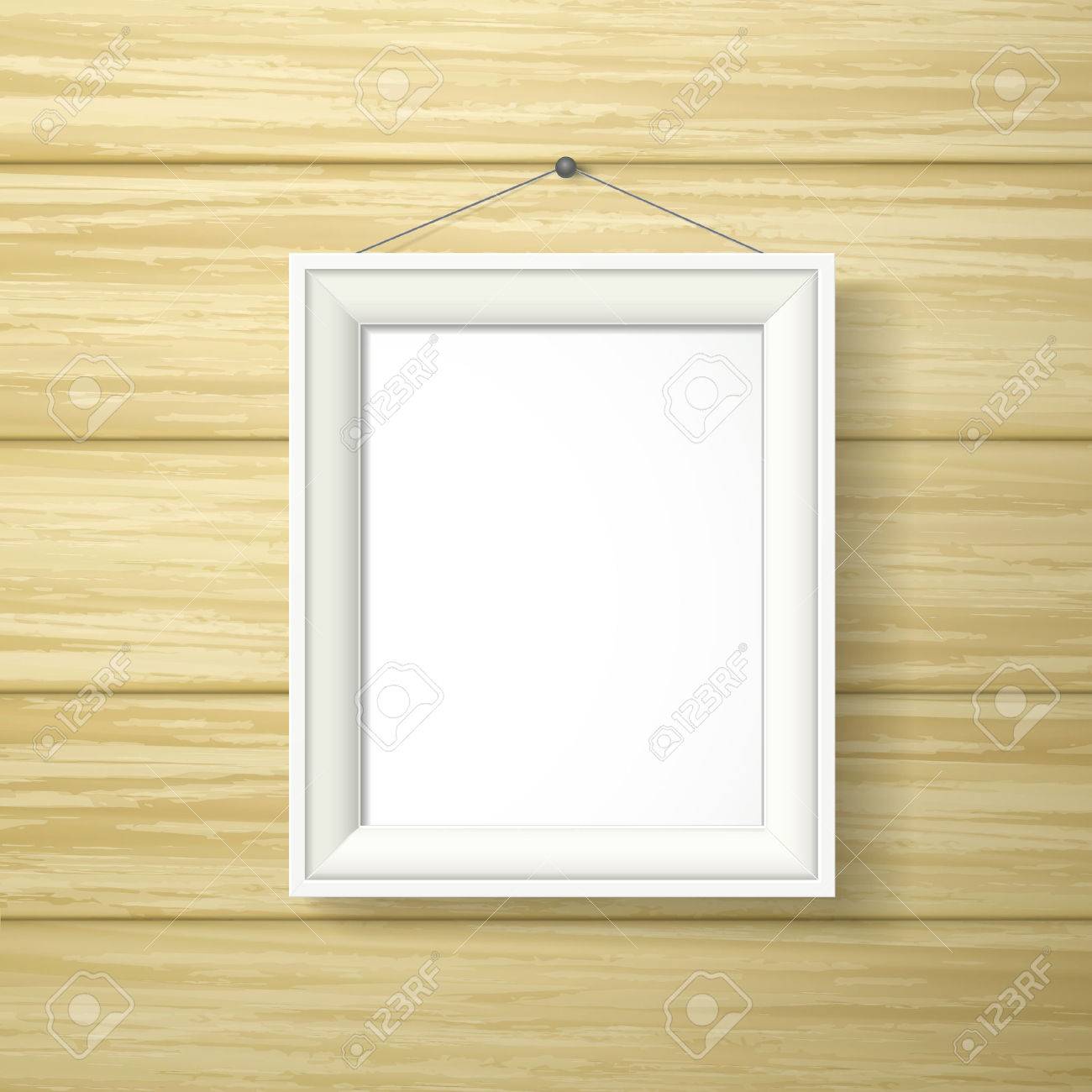 Blank White Photo Frame Hanging On The Wooden Wall Royalty Free