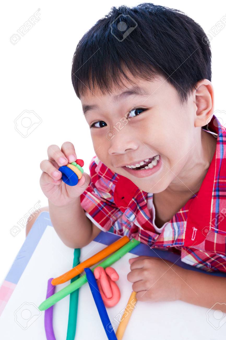 little asian boy playing and creating toys from play dough child child works child play