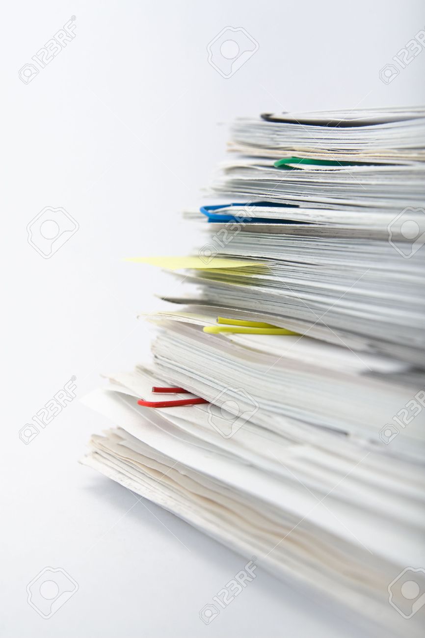 big pile of different coloured office papers in files and folders office papers