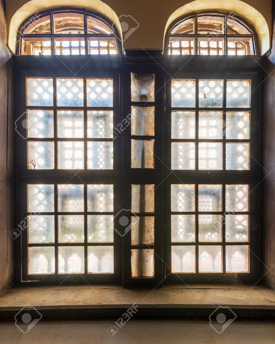 Large grunge vintage window with ornament located inside empty room - 151743132 Large grunge vintage window with ornament located inside empty room - 151743132