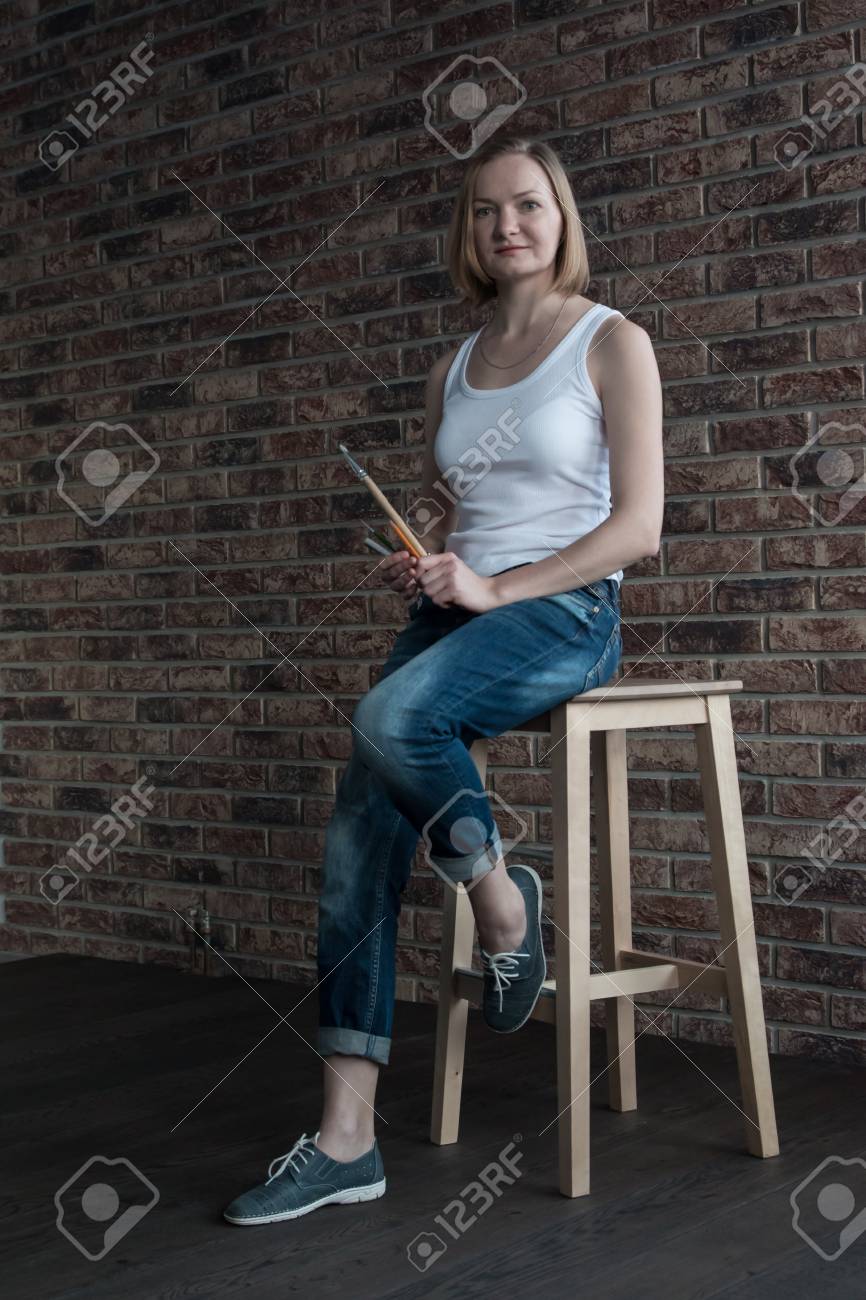 Female Artist With Short Blonde Hair In The Room Stock Photo