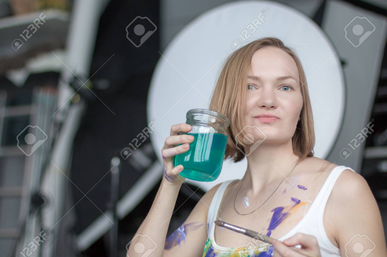 Female Artist With Short Blonde Hair In The Room Stock Photo