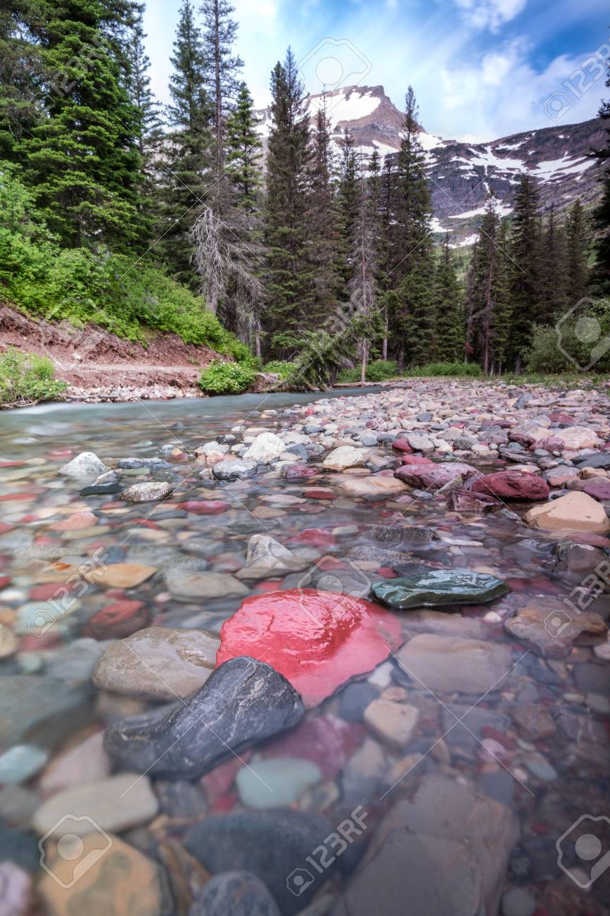 rocks in creek below mount grinnell in montana stock photo picture